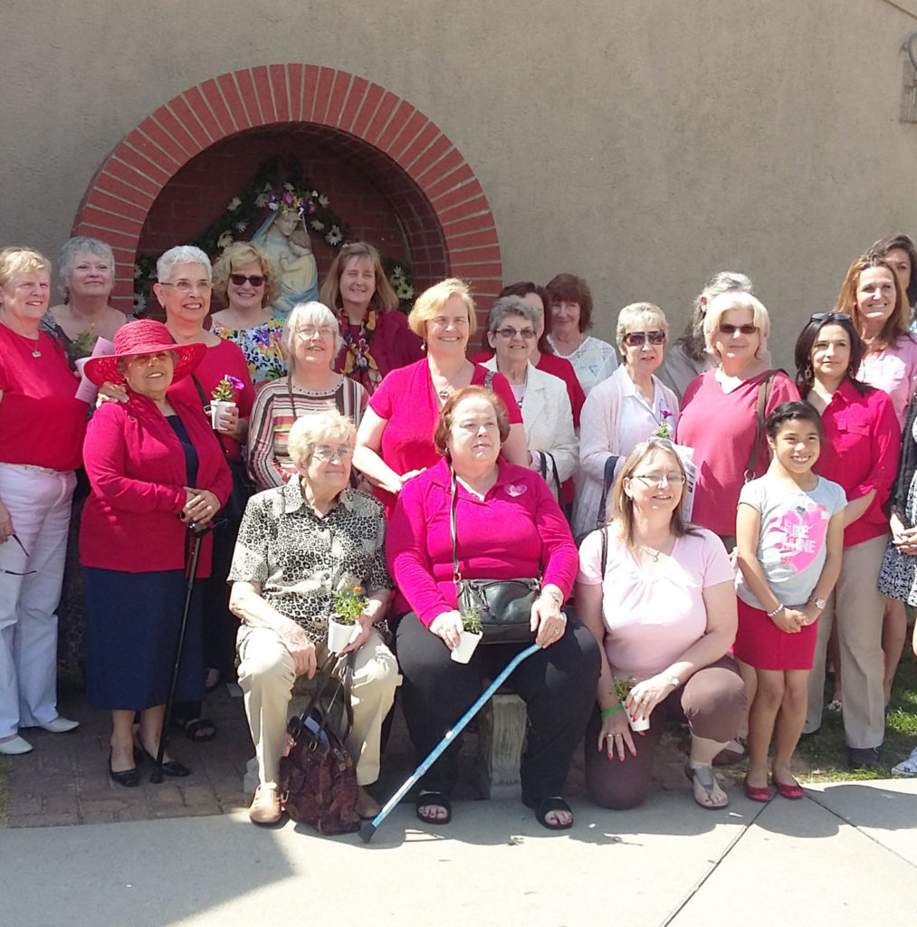 A large group of women pose for a photo outdoors during a Heart To Heart event